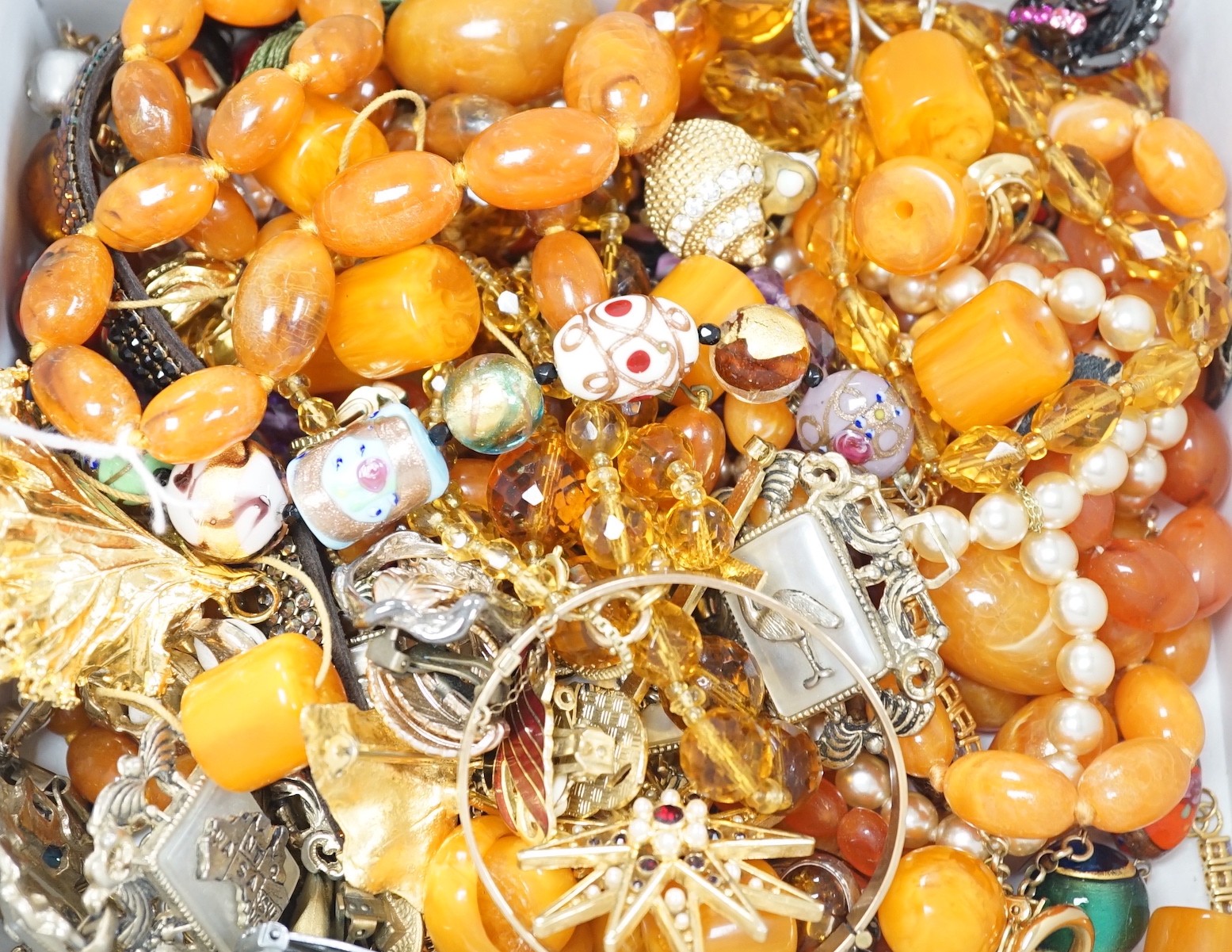 Mixed costume jewellery, including simulated amber necklaces.
